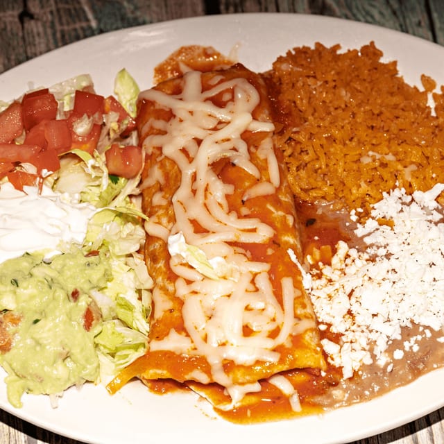 3 - Burrito covered with red sauce, cheese.