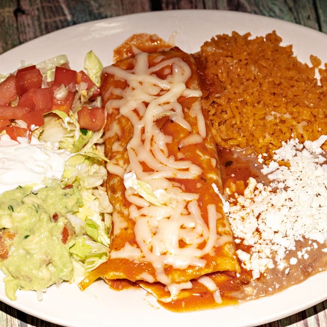 4 - Burrito covered with cheese dip.